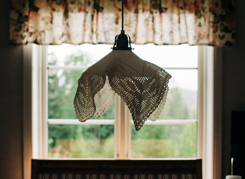 Swedish embroidered lamp hanging in a summer house