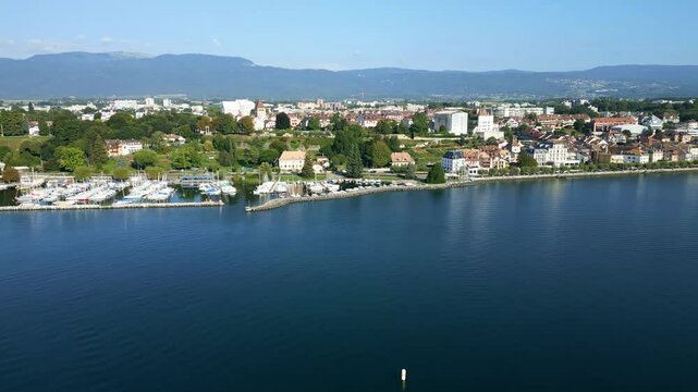 Push in drone shot of the Lake of Geneva and the city of Nyon in Canton of Vaud in Switzerland.