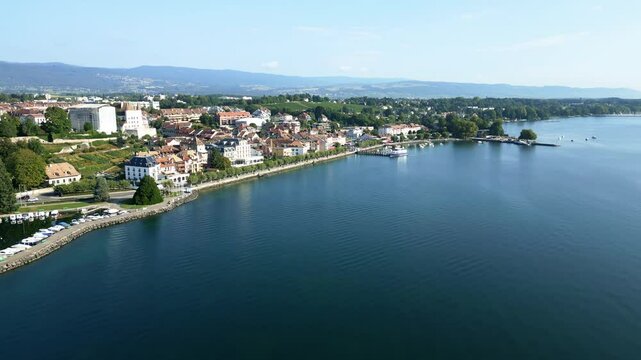 Push in drone shot of the port of Nyon with the castle and the Lake of Geneva.
