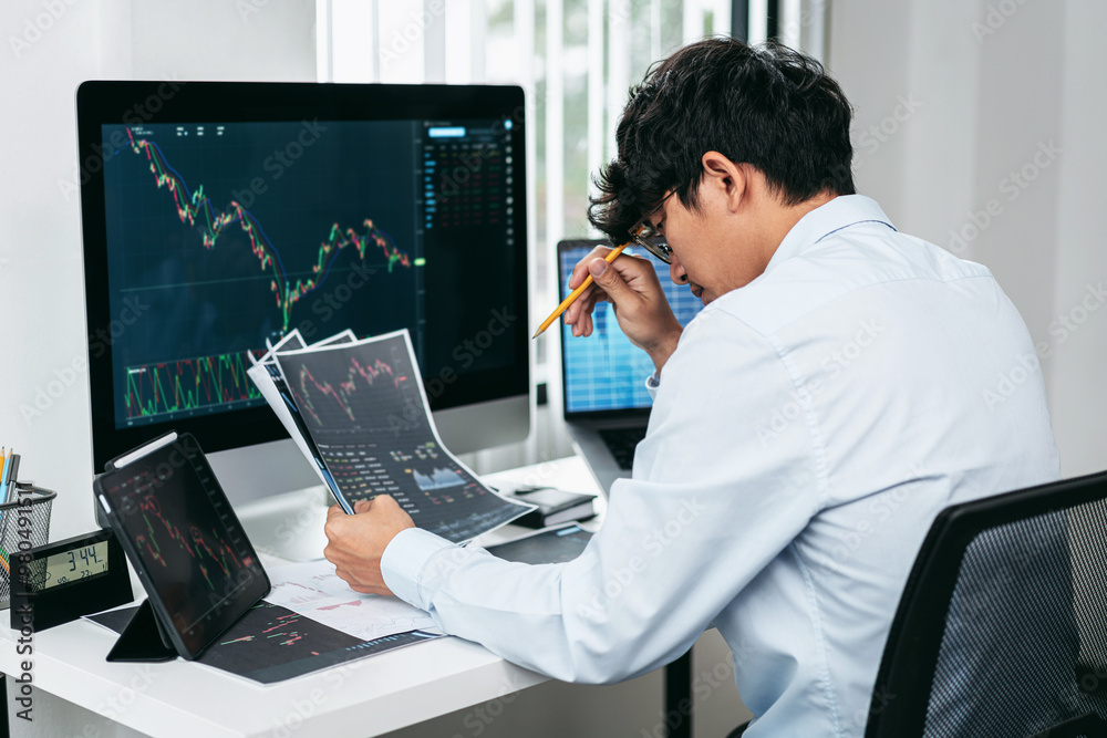 Poster businessman investor working and stress with computer analyzing graph stock market trading planning 