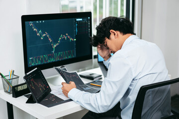 Businessman investor working and stress with computer analyzing graph stock market trading planning with chart data financial investment planning