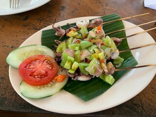 Balinese Grilled Squid with Dabu Dabu Chili Sauce. Spicy Indonesian condiment sambal made of tomato, garlic and shallot with lemon basil
