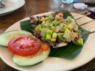 Balinese Grilled Squid with Dabu Dabu Chili Sauce. Spicy Indonesian condiment sambal made of tomato, garlic and shallot with lemon basil