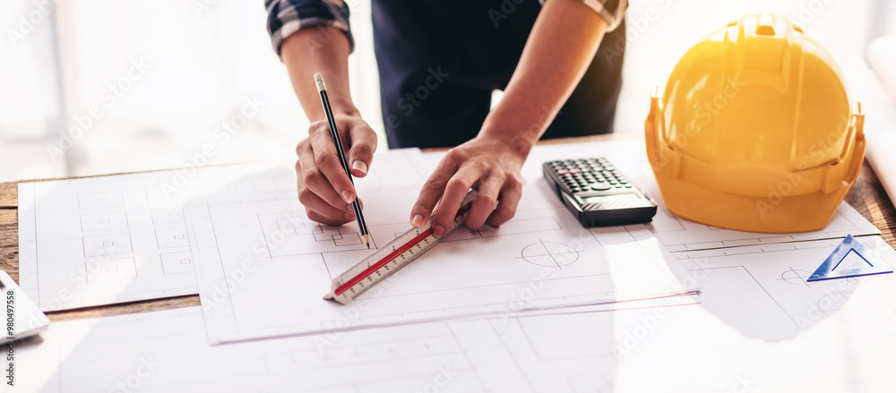 Poster a person is drawing a blueprint with a ruler and a pen