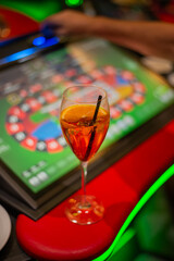cocktail glass in front of gambling table, casino concept