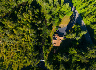 A house is seen from above in a forest
