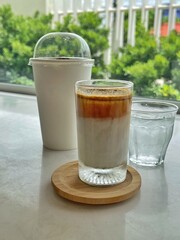 Dirty Coffee - A glass of espresso shot mixed with cold fresh milk on blurred background and copy space, Perfect drink for summer time.
