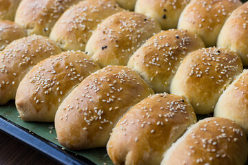 Homemade pies sprinkled with sesame seeds. Appetizing homemade cakes
