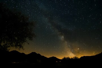 Fototapeta premium A dark night sky with stars and the Milky Way galaxy in view. 