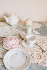 a teacup and saucer are on a table with a plate, tea time