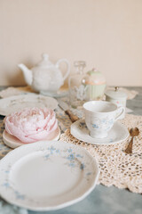 a teacup and saucer are on a table with a plate, tea time