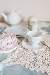 a teacup and saucer are on a table with a plate, tea time