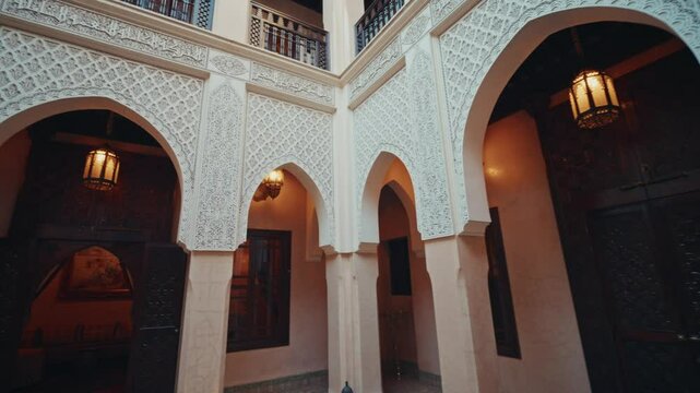 Panoramic overview inside a traditional Riad in Marrakesh, Morocco. View of the beautiful interior decorations and the traditional moroccan architecture.