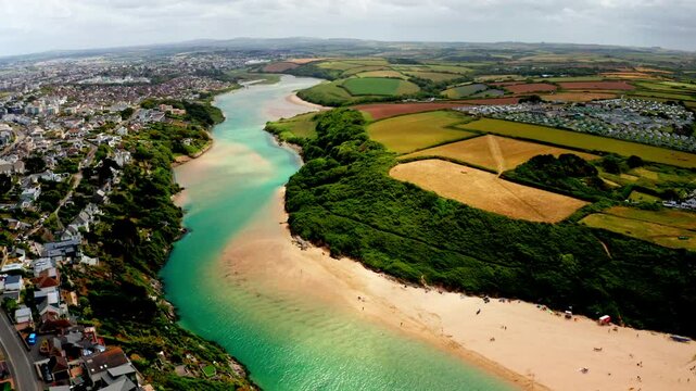 Aerial drone shot over the coastal town of Newquay in Cornwall, United Kingdom. High view of the Gannel river.