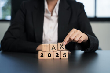 ax 2025 icon in the wooden cube for income tax return and submit tax for payment tax documents online to the government.