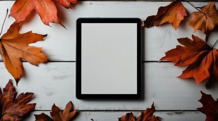 Modern autumn mockup with blank tablet nestled among vibrant fallen leaves on rustic wooden surface