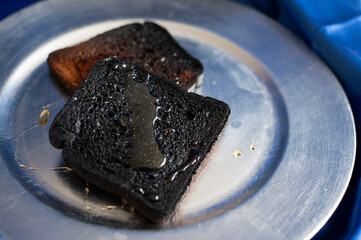 Burnt bread on the silver plate