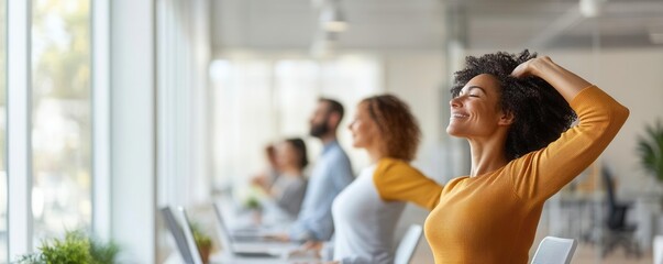 Group of coworkers stretching during a break in a bright, open office space, representing employee wellness initiatives