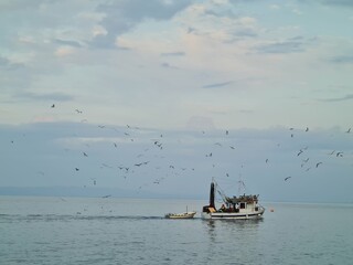 boat on the sea. rocks and sea. sunrise over the sea