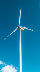 white wind turbine against blue sky with clouds