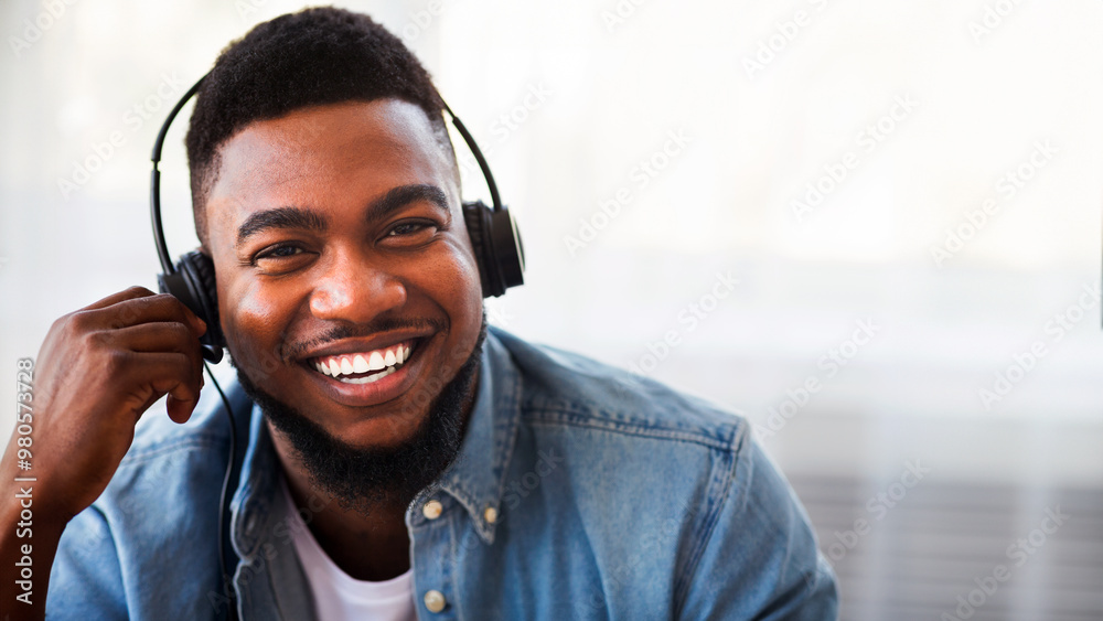 Poster call center operator. portrait of smiling black customer service representative in headset, closeup