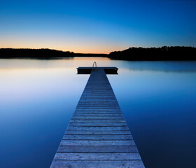 Wooden Pier by Calm Lake at Dusk