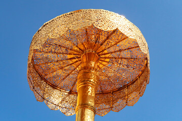 The elaborate golden umbrella, parasol next to the golden central stupa, pagoda of the Wat Phra...