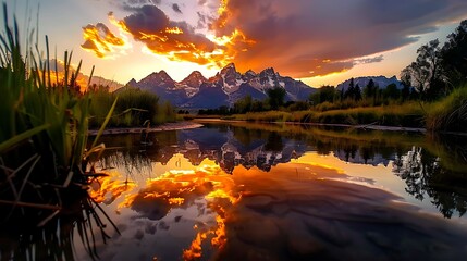 majestic grand teton mountains reflected in snake river the grand tetons are reflected in the calm waters of the snake river at sunrise. 