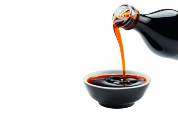 Dark soy sauce poured from bottle isolated on white transparent background.