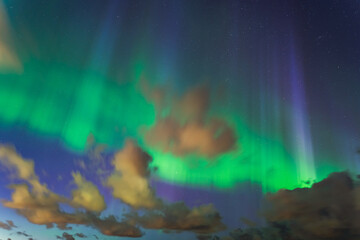 Astrophotography, starry sky, clouds and northern lights. Nature of Estonia.