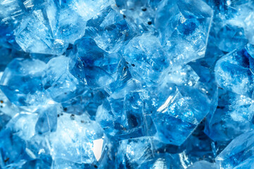 Blue Crystal Mineral Stone. Gems. Mineral crystals in the natural environment. Texture of precious and semiprecious stones. Seamless background with copy space colored shiny surface of precious stones