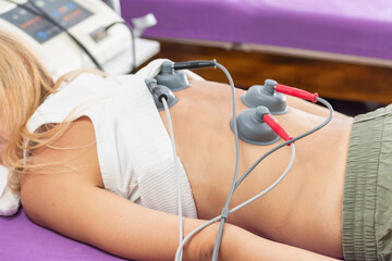 Physical therapist performs vacuum therapy on a patients back to alleviate muscle tension, improve...