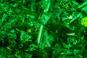 Green crystal mineral stone. Gems. Mineral crystals in the natural environment. Texture of precious and semiprecious stones. Seamless background with copy space colored shiny surface of precious stone