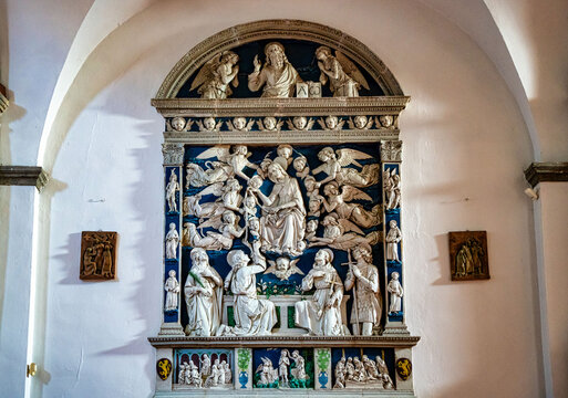 Glazed terracotta altarpiece by the master Luca della Robbia. Work of the early Renaissance 14th century in the parish church of Saints Flora and Lucilla in Santa Fiora Tuscany Italy