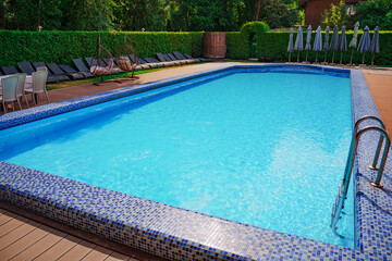 large swimming pool. ripples on the blue water in the pool. water purification in swimming pools. Relaxing in the water.