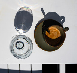 Cup of espresso and glass of water on the table in cafe