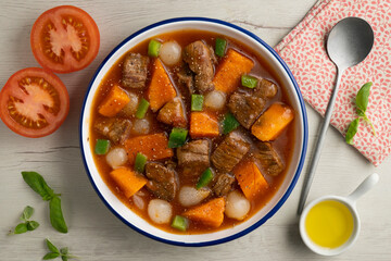 Beef stew with pumpkin and green beans. Top view table with  decoration.