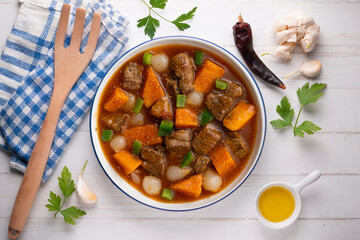 Beef stew with pumpkin and green beans. Top view table with  decoration.