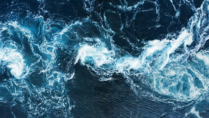 Dramatic sea waves storm from aerial view. Deep dark blue ocean water texture background. Top view