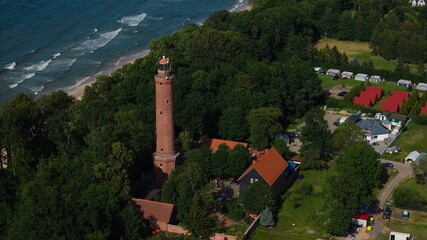 Aerial of Gąski lighthouse and sandy Baltic beach on a bright summer day. © Grzegorz