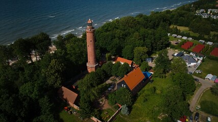 Aerial photo of Gąski lighthouse, beach, and the clear Baltic Sea. © Grzegorz