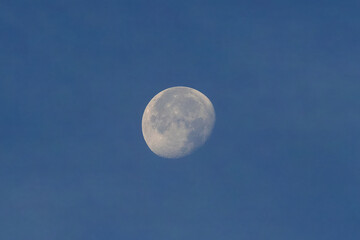 Full moon over blue sky