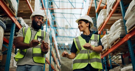 Dance, smile and walking with people in warehouse together for distribution, inventory or storage. Celebration, industry or logistics with man and woman employee in supply chain plant for shipping