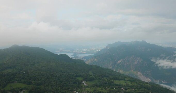 Lombardy, Italy - A Picturesque View of Grignetta's Peaks Shrouded in Fog, Stretching High Into the Sky - Drone Flying Forward
