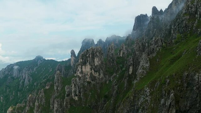 Lombardy, Italy - The Jagged Mountain Summit Veiled in Fog, Atop Grignetta - Pan Up Shot
