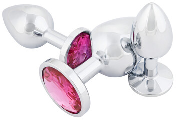 Set stainless steel anal butt plugs with a pink crystal different sizes isolated on a transparent...
