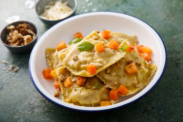 Homemade pumpkin ravioli with herbs and cheese