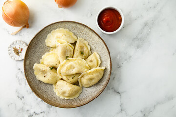 Homemade dumplings with potato and onion