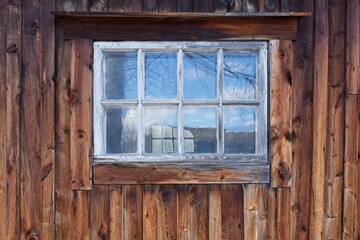 Closed window on a old weathered timber wall.
