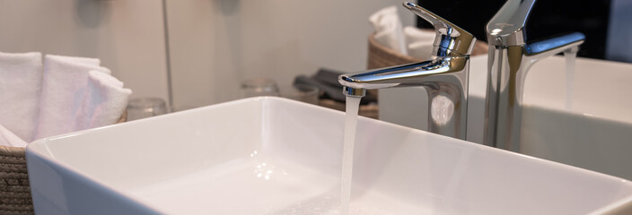 Water flowing from an open faucet, ecological concept